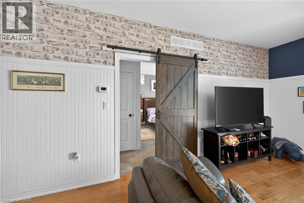 Sliding barn-style door leads to the primary suite. - 6 Gaddye Lane, Binbrook, ON - Indoor