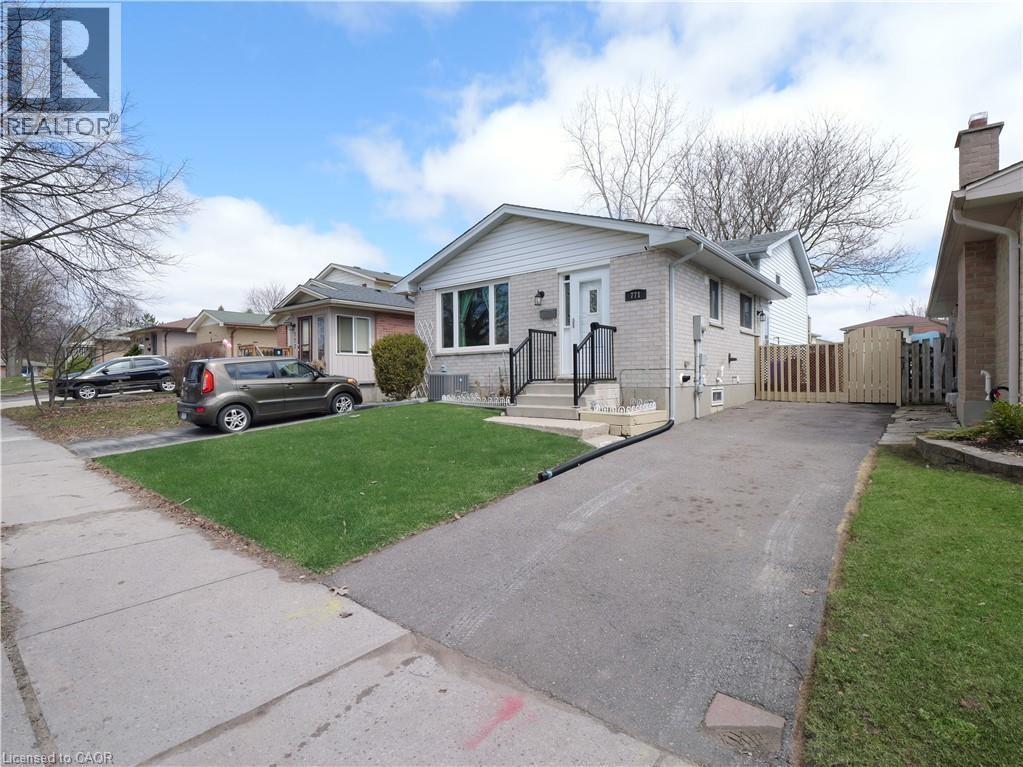 Split-level residence featuring a light brick facade and white siding - 771 Monsarrat Avenue, London, ON