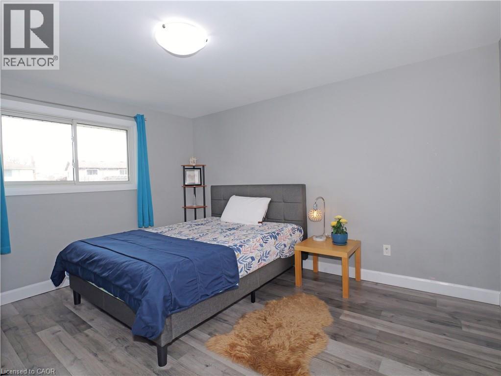 Bright room featuring gray walls, wood-finish flooring, and a large window with white trim - 771 Monsarrat Avenue, London, ON