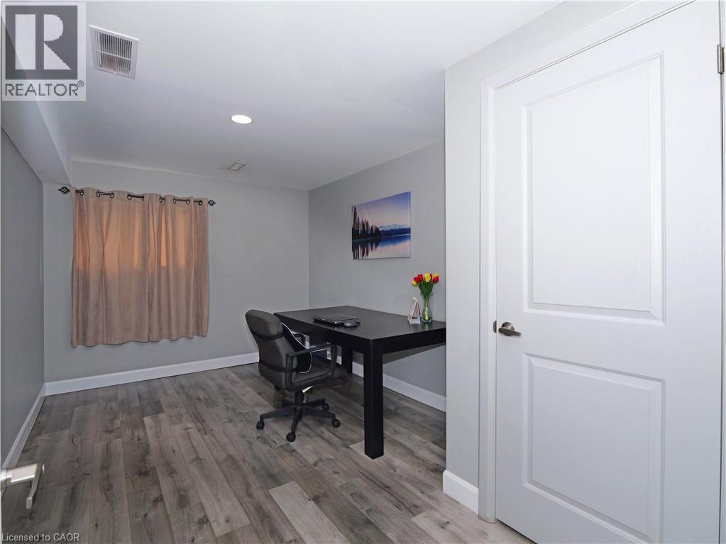 Room featuring wood-finish flooring, recessed lighting, and a window with curtain rod - 771 Monsarrat Avenue, London, ON