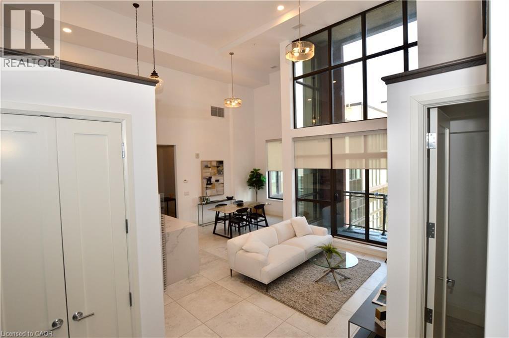 Expansive living area featuring soaring ceilings and oversized windows with roller shades - 112 King Street E Unit# Ph6, Hamilton, ON - Indoor Photo Showing Other Room