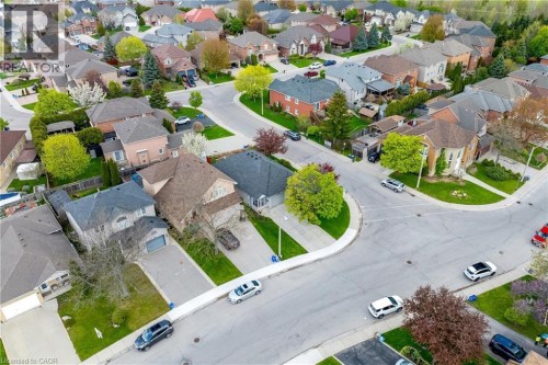Residential neighborhood featuring a curvilinear street design, individual driveways, and mature trees - 50 Spadara Drive, Hamilton, ON - Outdoor With View