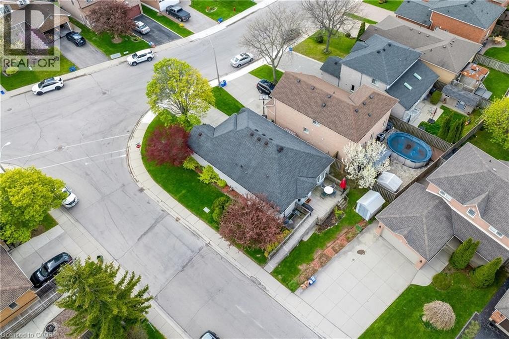 Aerial perspective of a property featuring a dark shingle roof and a concrete patio - 50 Spadara Drive, Hamilton, ON - Outdoor With View