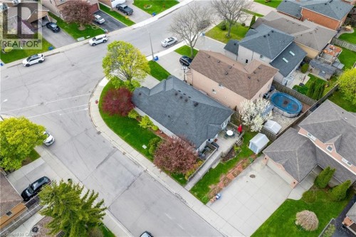 Aerial perspective of a property featuring a dark shingle roof and a concrete patio - 50 Spadara Drive, Hamilton, ON - Outdoor With View