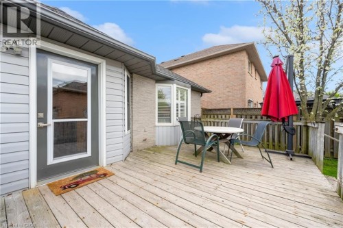 Wood deck with wood railing, featuring gray siding and a full-light exterior door - 50 Spadara Drive, Hamilton, ON - Outdoor With Deck Patio Veranda With Exterior