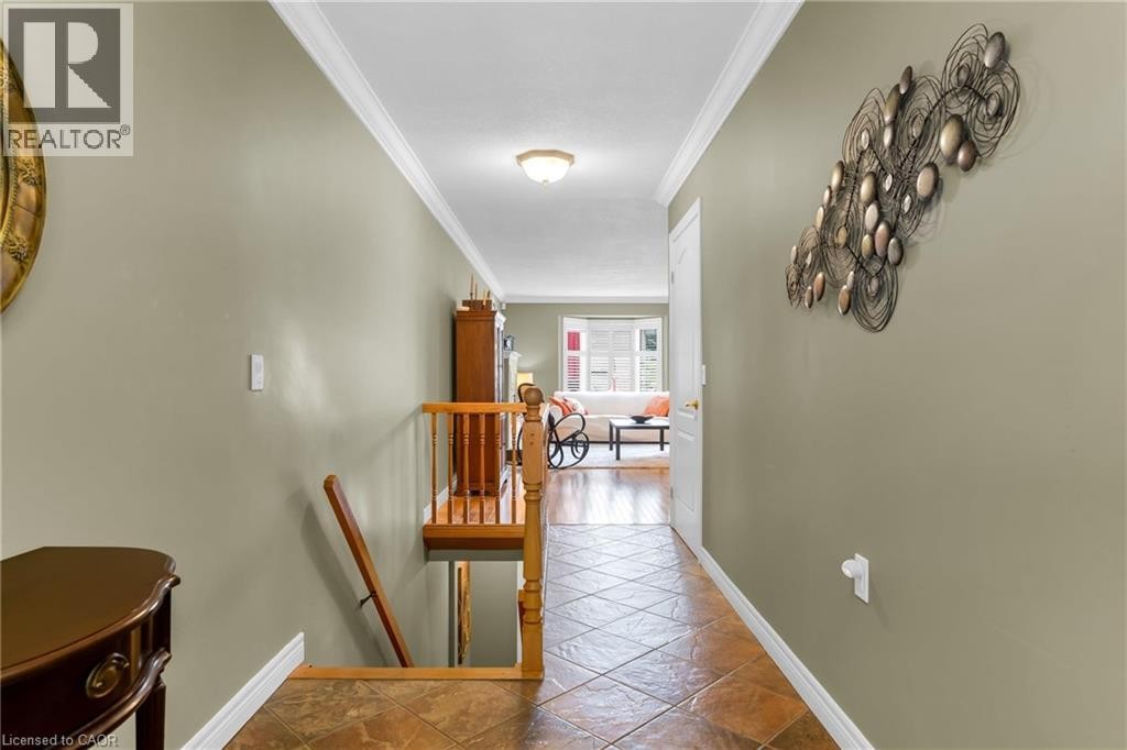 Hallway featuring wood-finish railing and tiled flooring - 50 Spadara Drive, Hamilton, ON - Indoor Photo Showing Other Room