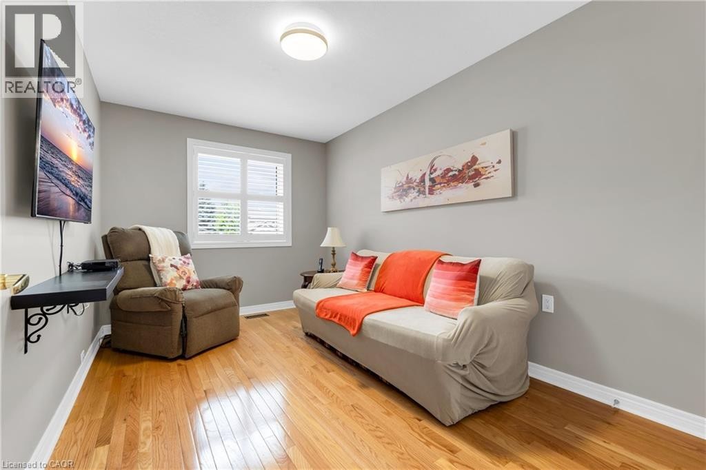Room featuring light wood-finish flooring, neutral gray wall paint, and white trim molding - 50 Spadara Drive, Hamilton, ON - Indoor Photo Showing Other Room