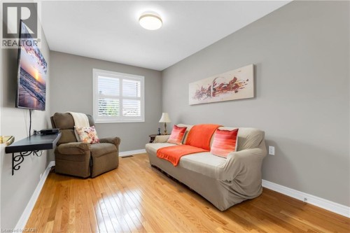 Room featuring light wood-finish flooring, neutral gray wall paint, and white trim molding - 50 Spadara Drive, Hamilton, ON - Indoor Photo Showing Other Room