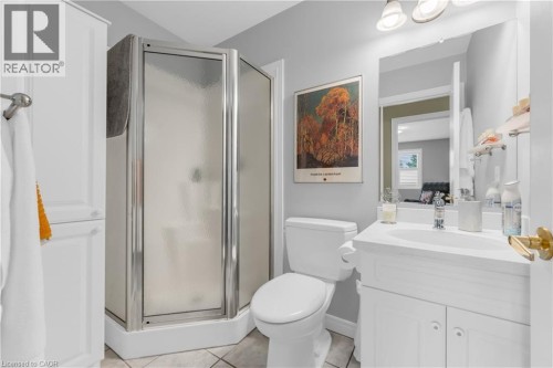 Bathroom with a corner shower enclosure, white vanity, and ceramic tile flooring - 50 Spadara Drive, Hamilton, ON - Indoor Photo Showing Bathroom