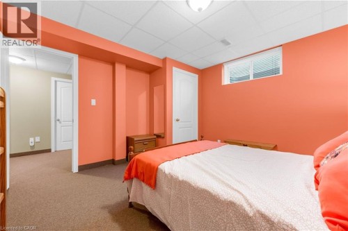 Carpeted room featuring a drop ceiling and a double-hung window - 50 Spadara Drive, Hamilton, ON - Indoor Photo Showing Bedroom