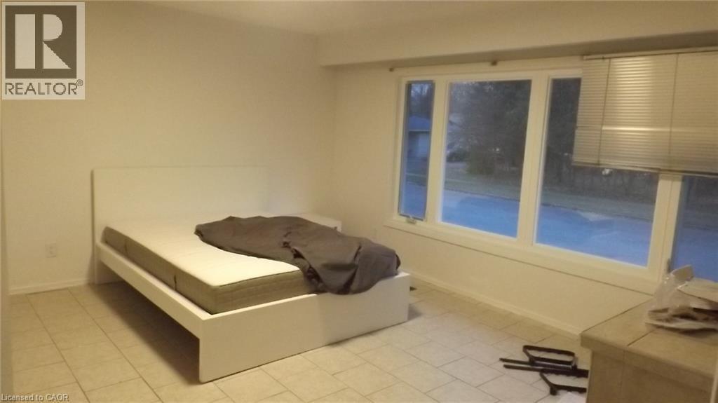 Room with light-toned tile flooring and white walls - 68 Austin Drive, Waterloo, ON - Indoor Photo Showing Bedroom