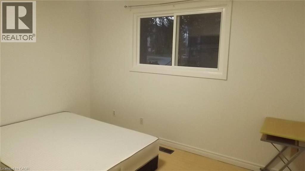 Room featuring a white-framed window, neutral wall paint, light-toned flooring, and white baseboards - 68 Austin Drive, Waterloo, ON - Indoor