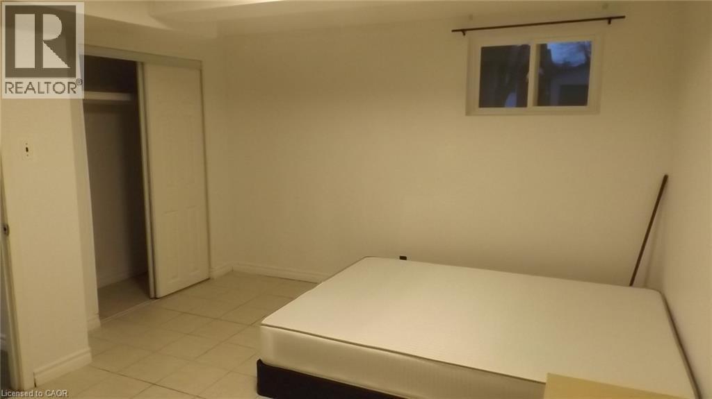 Room with light-toned tile flooring and white baseboards - 68 Austin Drive, Waterloo, ON - Indoor Photo Showing Other Room