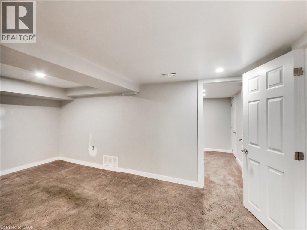 Carpeted room with recessed lighting and exposed ceiling beams - 229 Parkdale Avenue N, Hamilton, ON