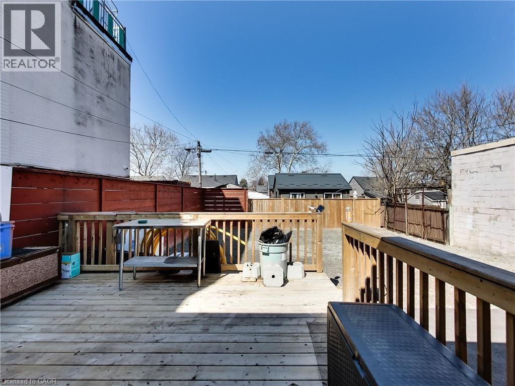 Expansive outdoor deck featuring wood-finish flooring and wood railings - 229 Parkdale Avenue N, Hamilton, ON