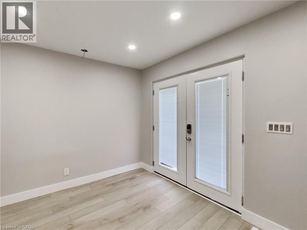 Room featuring light wood-finish flooring and neutral wall tones - 229 Parkdale Avenue N, Hamilton, ON