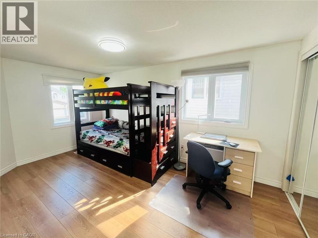Bright room featuring wood-finish flooring and white walls - 136 Hidden Creek Drive, Kitchener, ON