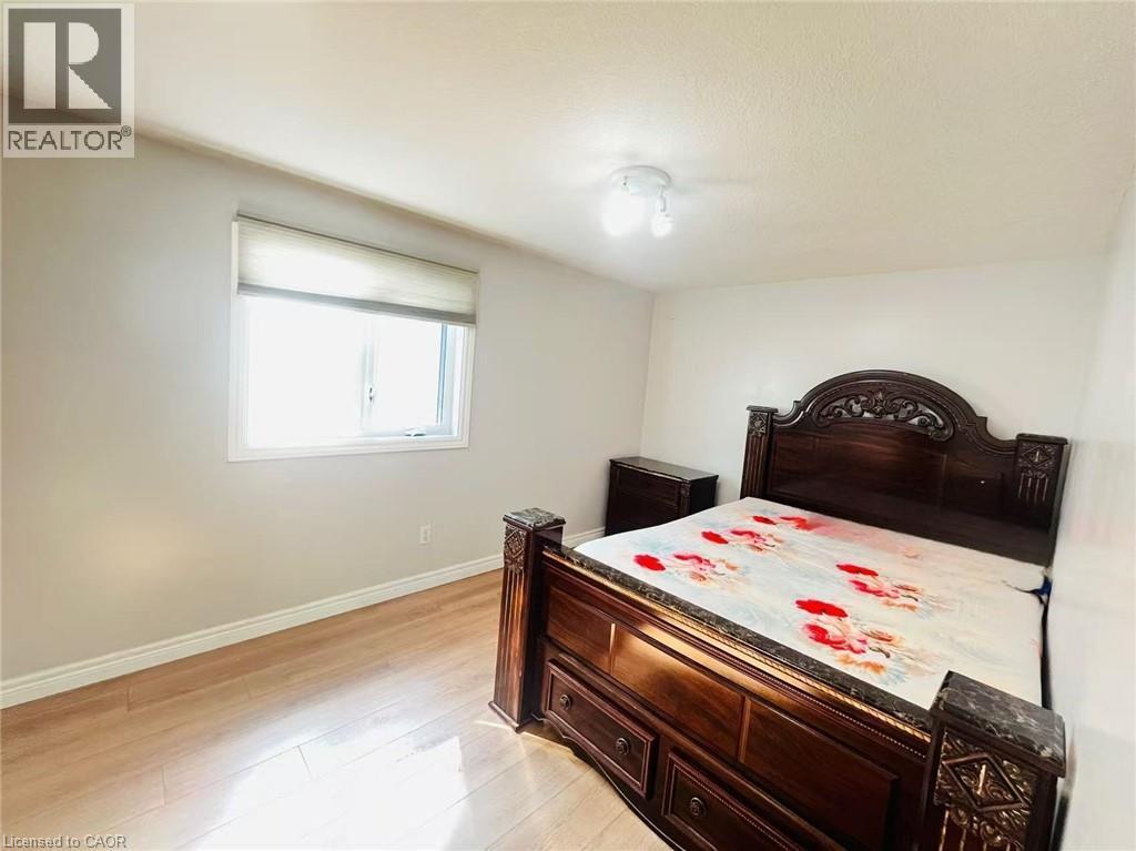 Bright room featuring light wood-finish flooring and a single window with a roller shade - 136 Hidden Creek Drive, Kitchener, ON
