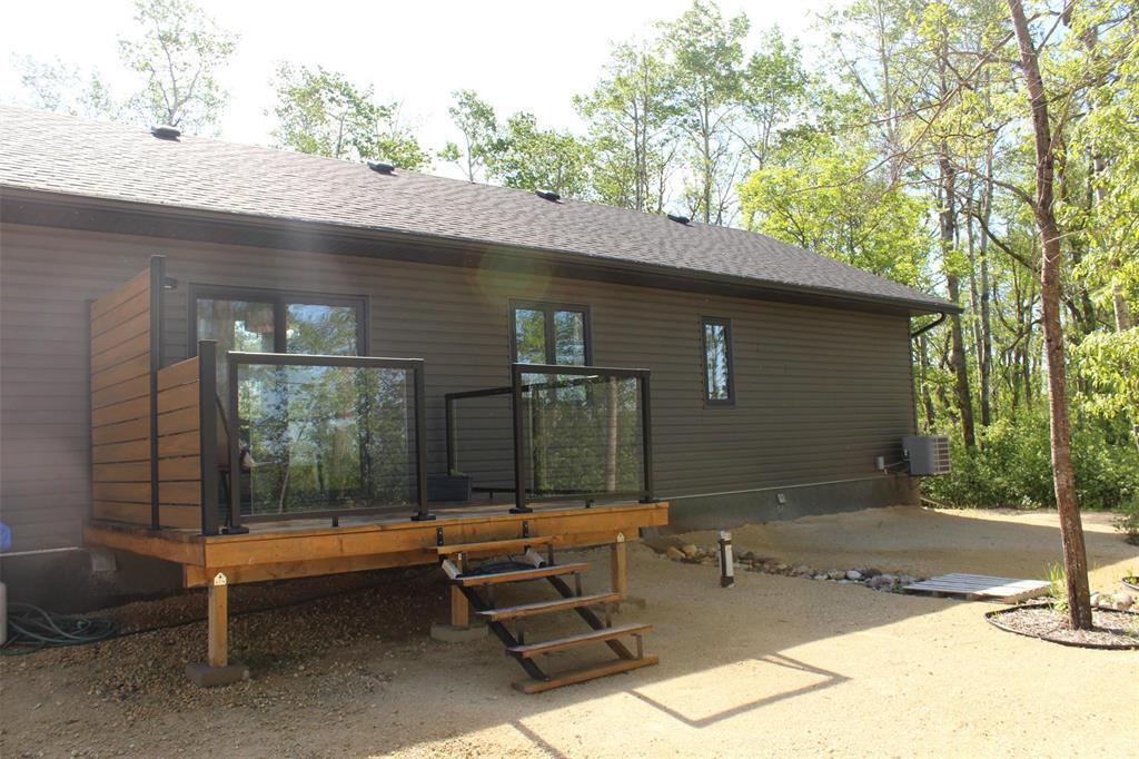 A view of the back of the house. Deck has privacy wall facing north, glass inserts and no maintenance railings. - 7 Dalvik Road, Gimli Rm, MB
