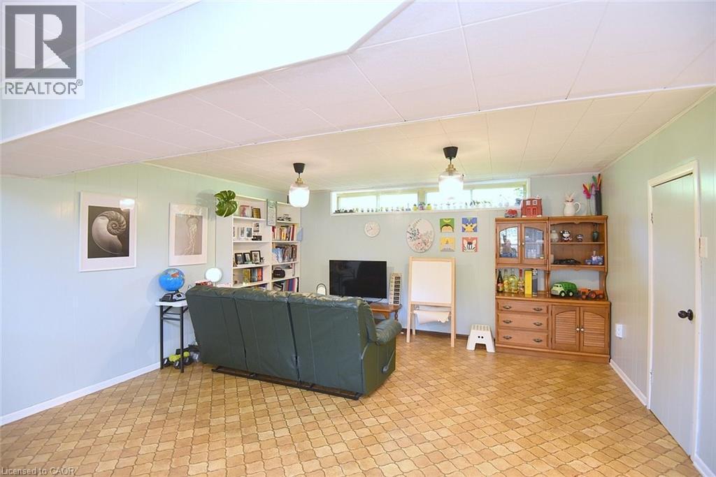 Finished basement space featuring light blue walls and patterned flooring - 372 Fennell Avenue W, Hamilton, ON