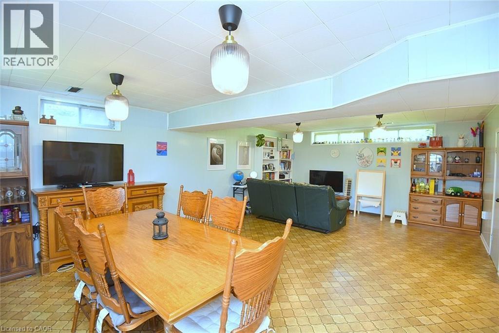 Spacious lower-level area with patterned flooring, panel wall accents, and recessed windows - 372 Fennell Avenue W, Hamilton, ON