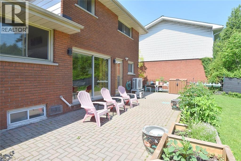 Expansive paver patio with direct access to interior spaces through a sliding glass door - 372 Fennell Avenue W, Hamilton, ON