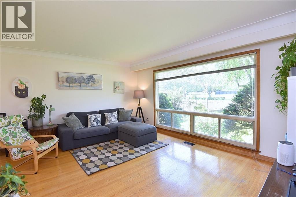 Expansive front window with natural wood trim and integrated blinds - 372 Fennell Avenue W, Hamilton, ON