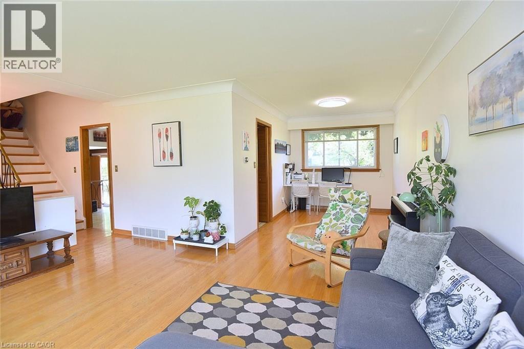 Bright interior space featuring wood-finish flooring, white walls, and crown molding - 372 Fennell Avenue W, Hamilton, ON