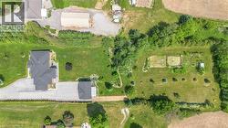 Expansive property featuring a multi-gabled main residence, a detached auxiliary building, and a large cultivated garden area -