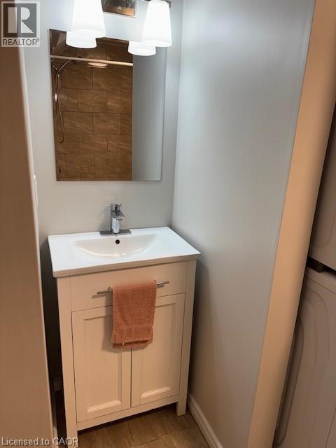 Compact vanity with white cabinet, integrated sink, and chrome faucet - 113 Cornerbrook Crescent Unit# 2, Waterloo, ON