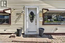 White front entry door with decorative glass insert and sidelights -
