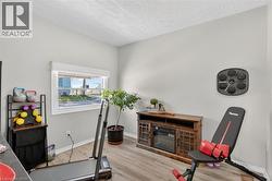 Light gray walls complement the wood-finish flooring in this versatile room -