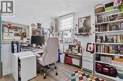 Dedicated workspace featuring wood-finish flooring and ample natural light -