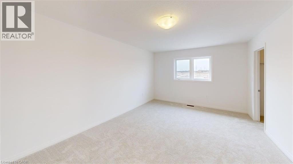 Bright room featuring light-colored carpeting, white painted walls, and a flush-mount ceiling light fixture - 287 Rockledge Drive, Hamilton, ON
