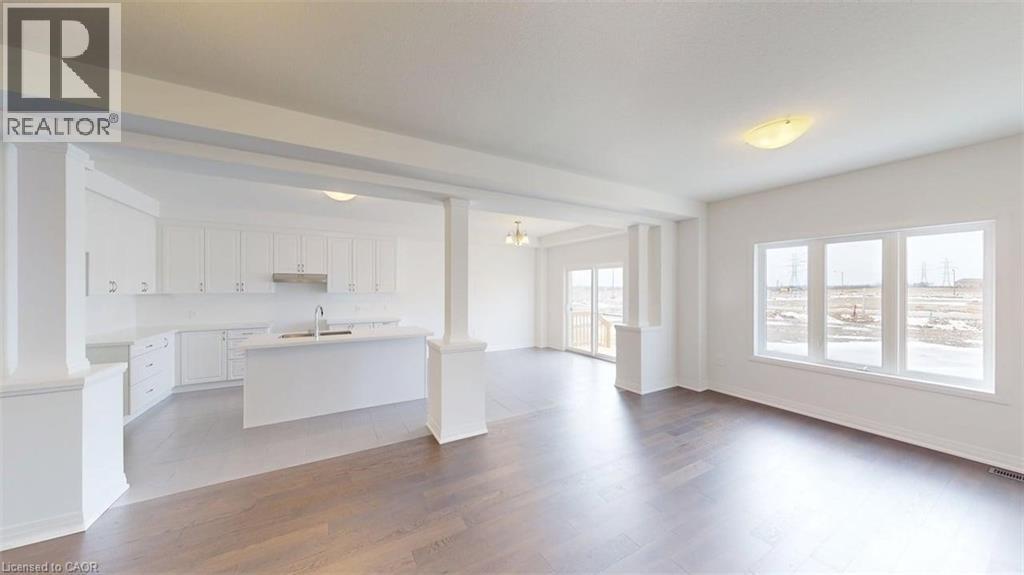 Open-concept living space featuring wood-finish flooring and ample natural light - 287 Rockledge Drive, Hamilton, ON
