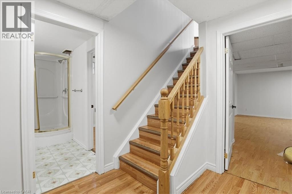 Wood-finish staircase with natural wood railing and balusters - 43 Decaro Crescent, Cambridge, ON