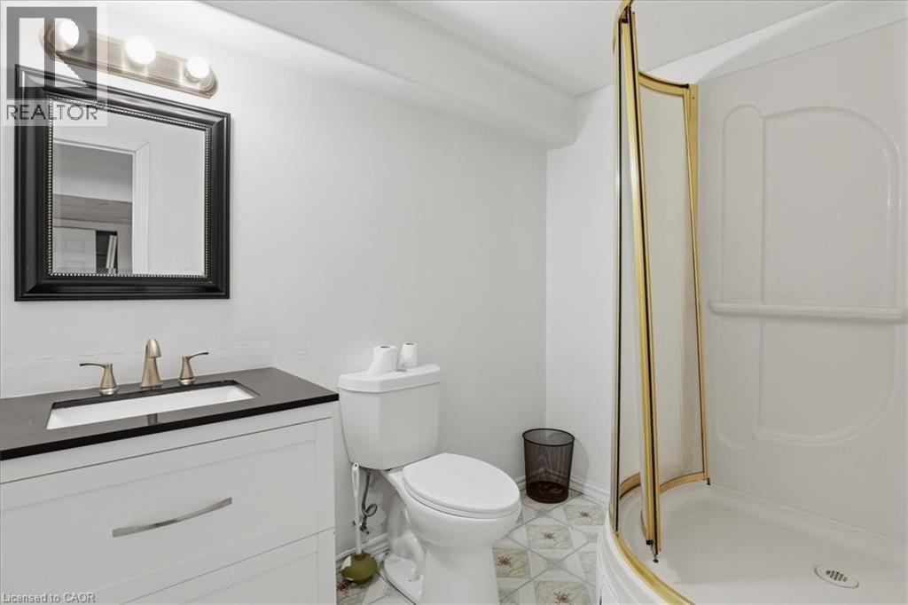 Full bathroom featuring a white vanity with dark countertop, undermount sink, and brushed nickel faucet - 43 Decaro Crescent, Cambridge, ON