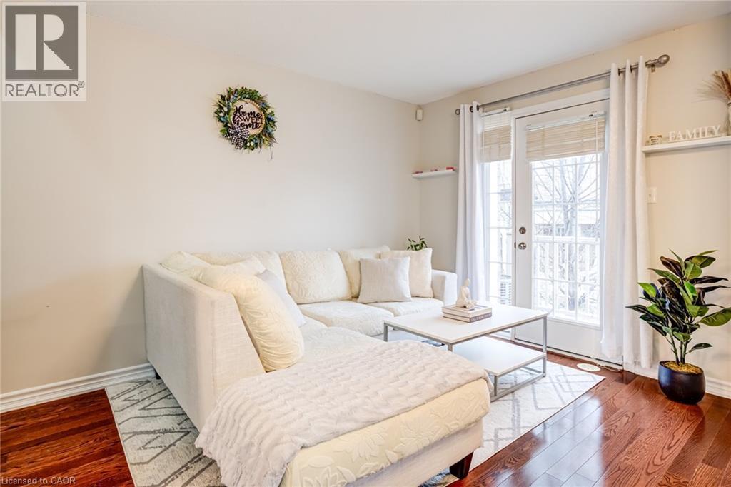 Hardwood-finish flooring complementing light-toned walls - 7 Sirente Drive Unit# 11, Hamilton, ON - Indoor