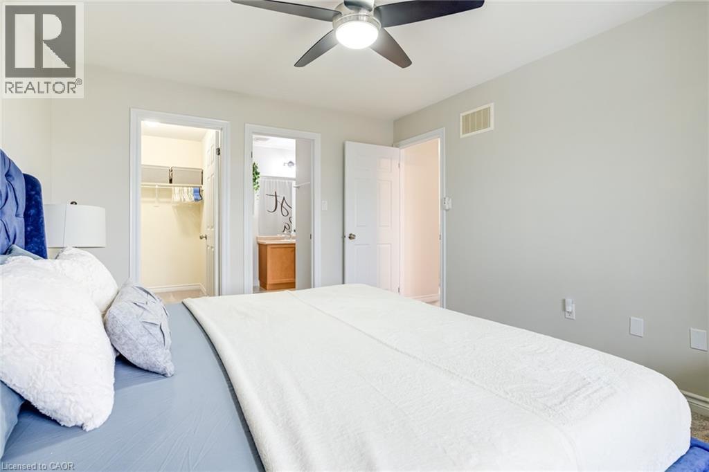 Bedroom featuring light gray walls, a ceiling fan with integrated lighting, and carpet flooring - 7 Sirente Drive Unit# 11, Hamilton, ON - Indoor Photo Showing Bedroom