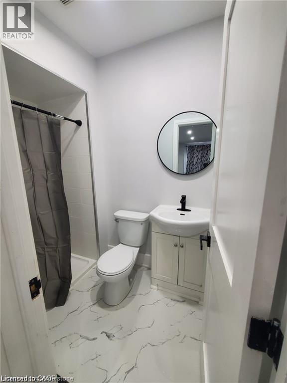 Bathroom featuring white walls and a white-and-gray patterned floor - 94 Brook Street, Simcoe, ON - Indoor Photo Showing Bathroom
