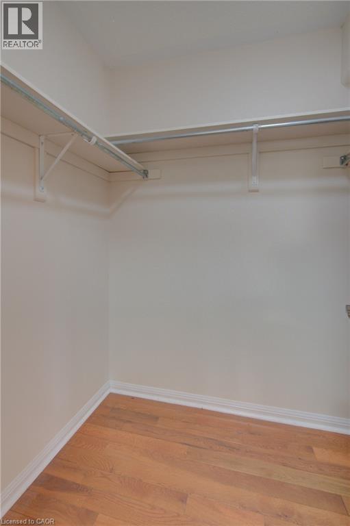 Built-in closet system featuring two levels of shelving and hanging rods - 180 Arthur Fach Drive, Cambridge, ON