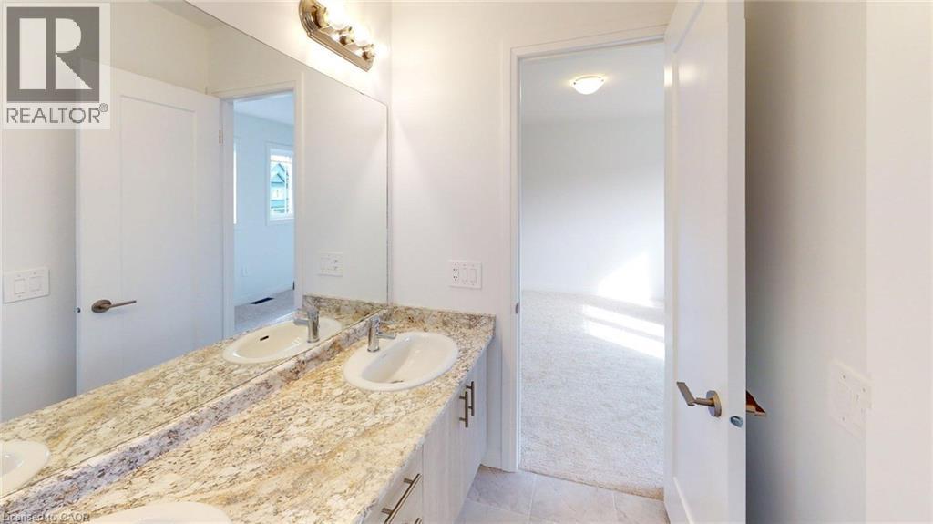 Double vanity with integrated sinks and a stone-finish countertop - 200 Cittadella Boulevard, Hamilton, ON