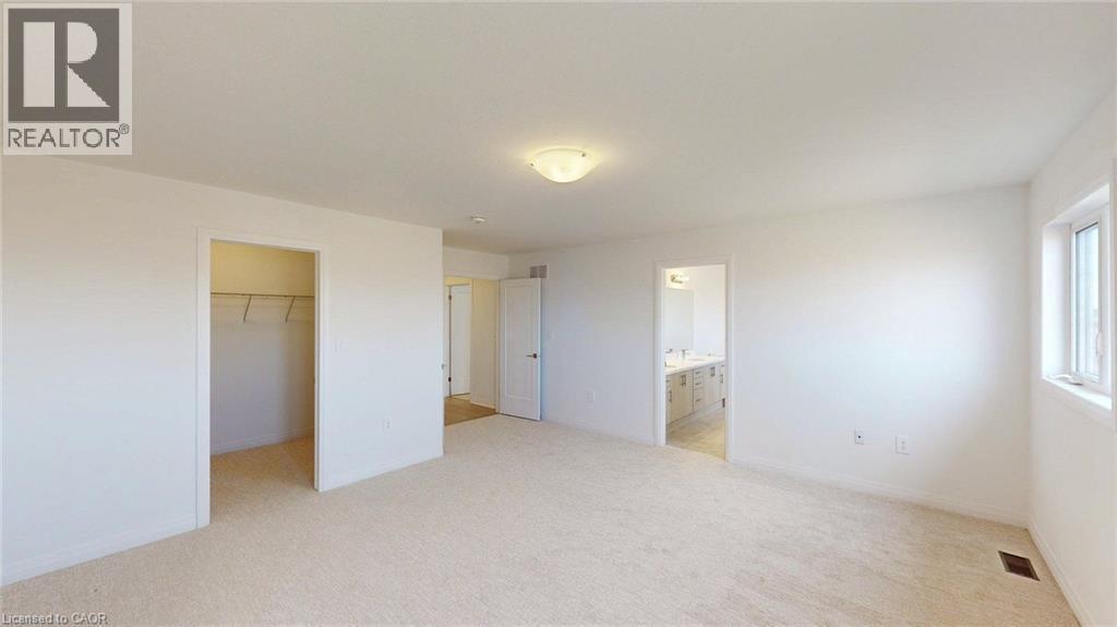 Spacious room featuring neutral carpeting, a large window, and an open closet - 200 Cittadella Boulevard, Hamilton, ON