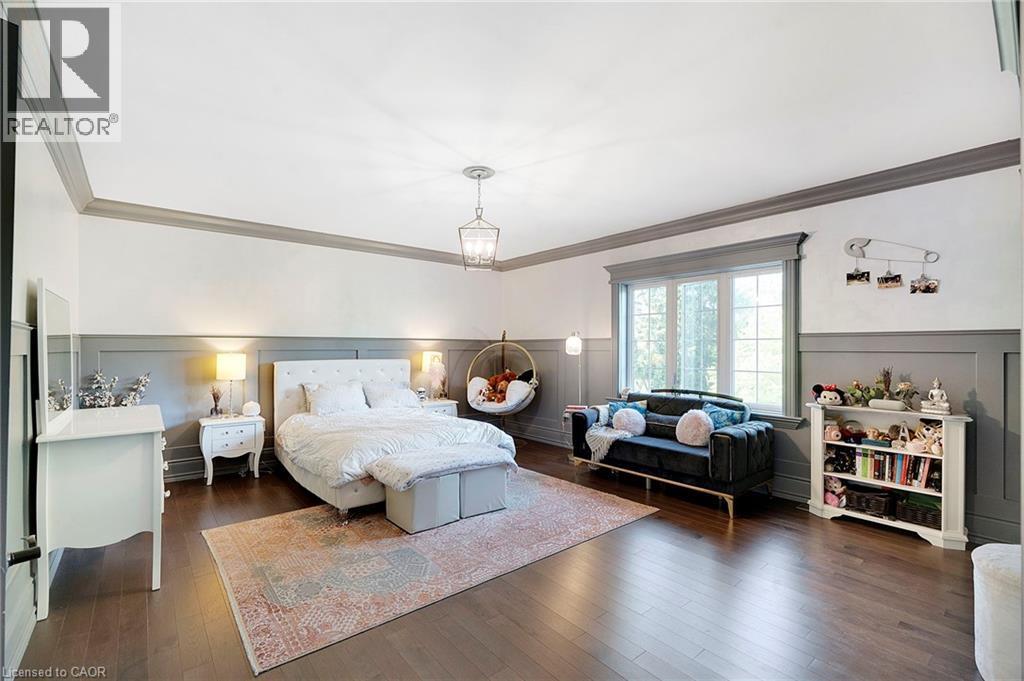 Spacious room featuring wood-finish flooring, wainscoting, and large picture windows - 6195 Milburough Line, Burlington, ON - Indoor Photo Showing Bedroom