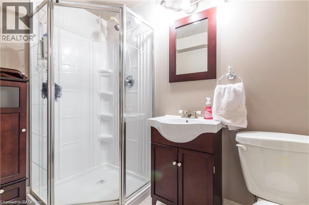 Corner glass shower enclosure with a white shower base and a chrome showerhead - 209 Auburn Drive Unit# A, Waterloo, ON