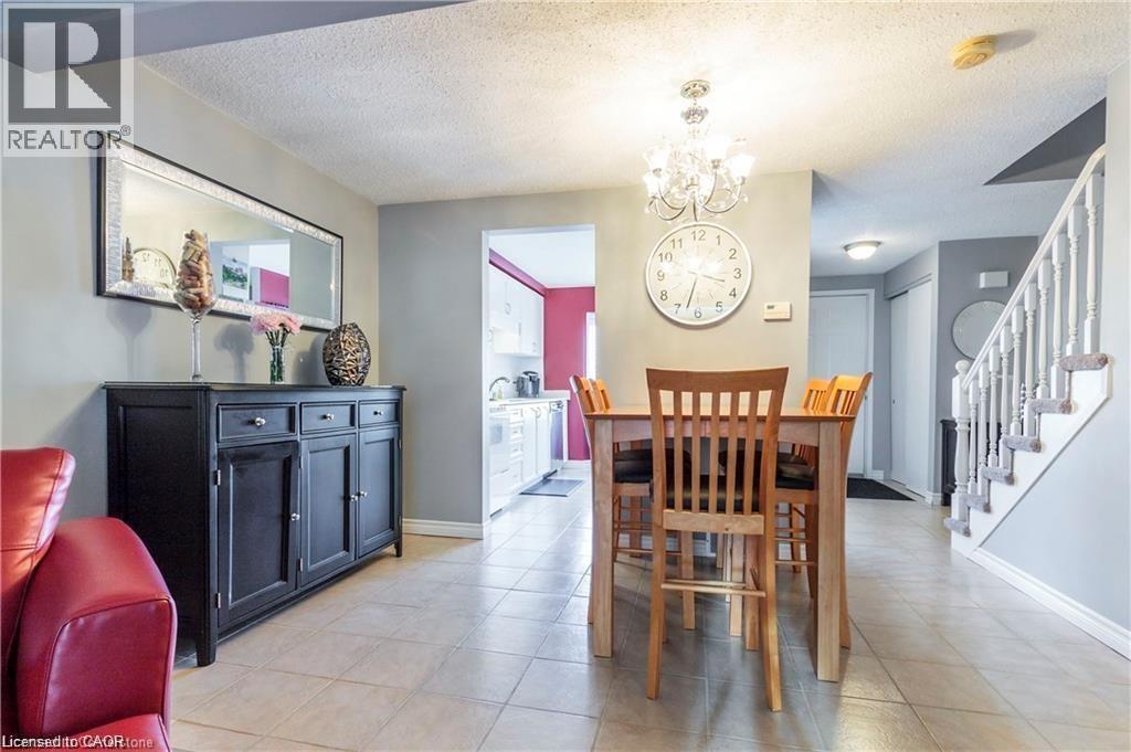 Dining area with tile flooring and a chandelier - 209 Auburn Drive Unit# A, Waterloo, ON