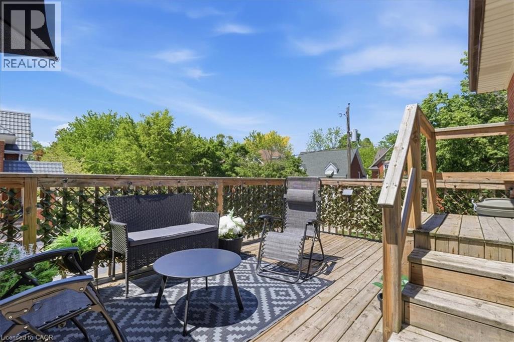 Wood deck featuring a wooden railing, privacy screening, and steps for access - 744 Queen Street S, Kitchener, ON
