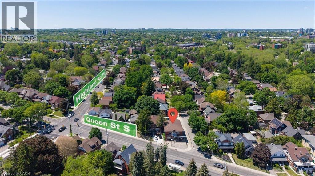 Aerial perspective showcasing a residential neighborhood with mature trees and varied architectural styles - 744 Queen Street S, Kitchener, ON