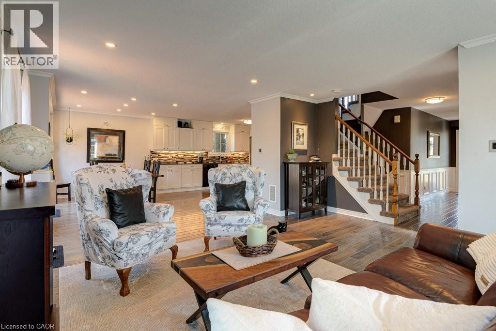 Expansive common area featuring wood-finish flooring, recessed lighting, and crown molding - 61 Ditner Avenue, Baden, ON - Indoor Photo Showing Living Room