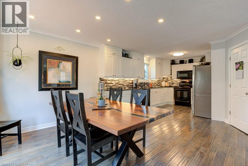 Open-concept dining area featuring wood-finish flooring, recessed lighting, and crown molding - 61 Ditner Avenue, Baden, ON - Indoor Photo Showing Dining Room